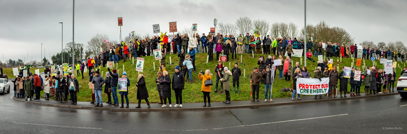 100s of supporters on an embankment protesting against Adlington New Town
