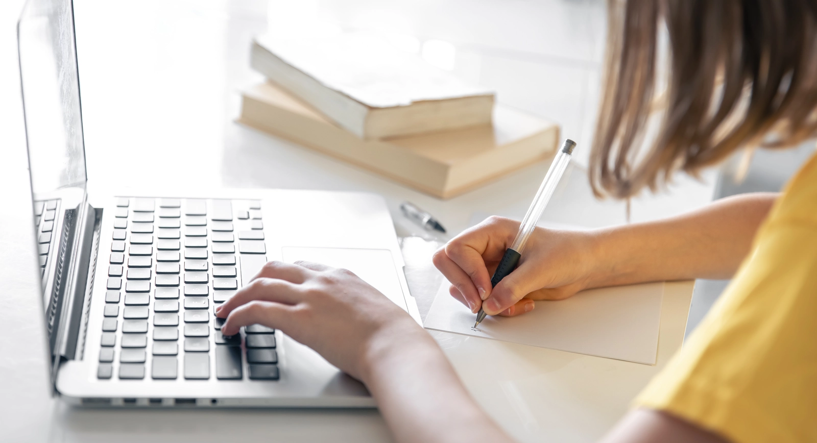 Teenage girl at Laptop with Books