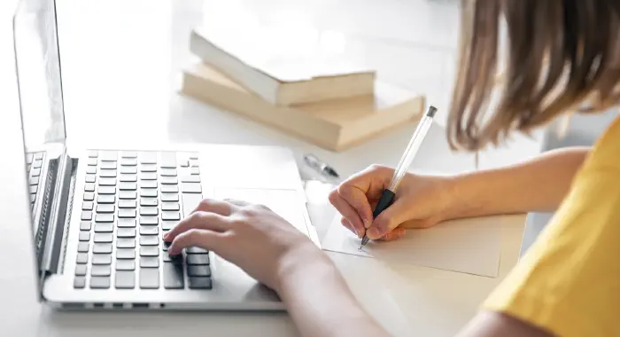 Teenage girl at Laptop with Books