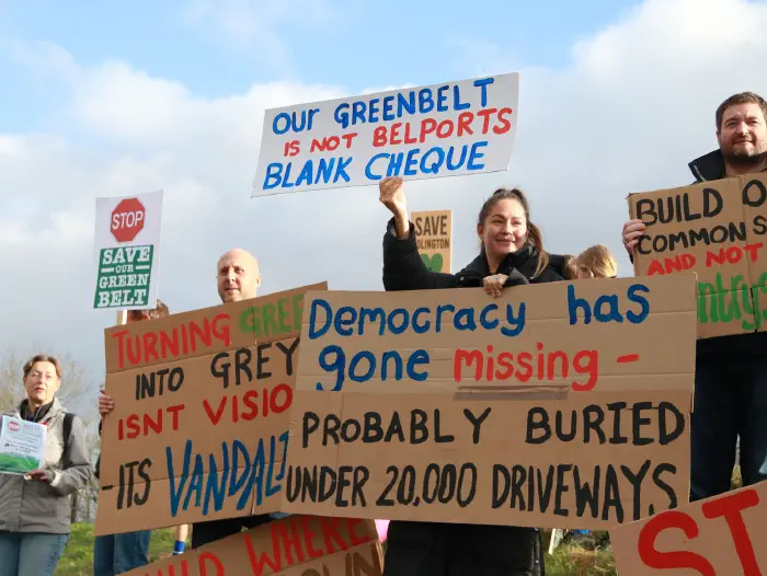 Families holding banners opposing the new town