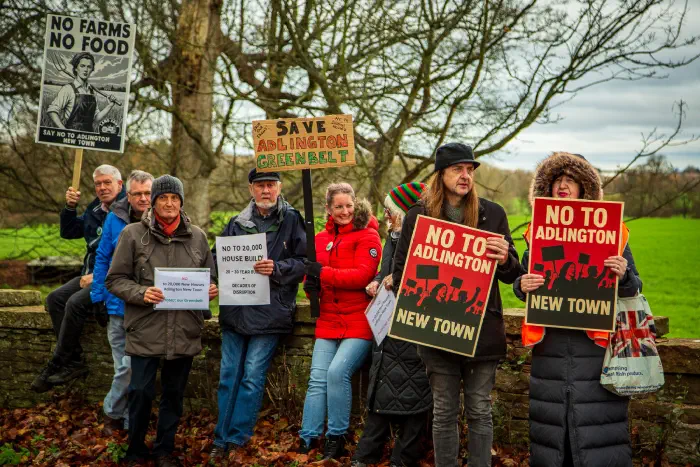 Protesters holding signs and placards