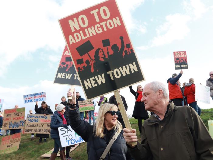 Protesters on side of road holding No to Adlington New Town placards