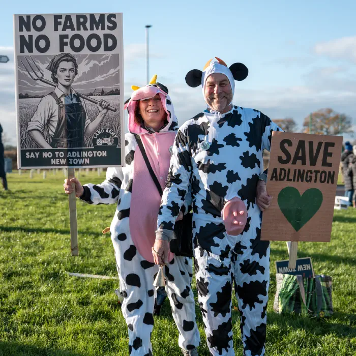 Protesters on side of road holding No to Adlington New Town placards