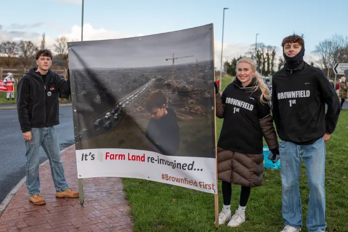 People holding brownfield first banner
