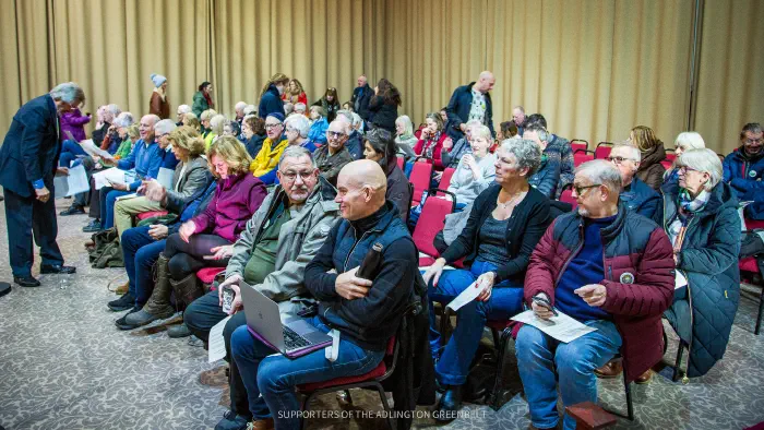Seated members of the public ready for the council meeting