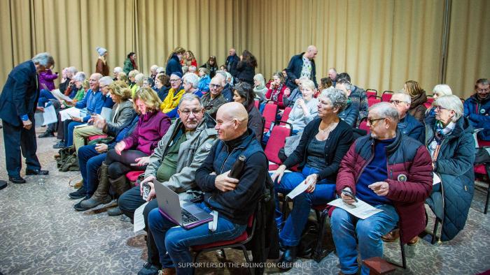Seated members of the public ready for the council meeting