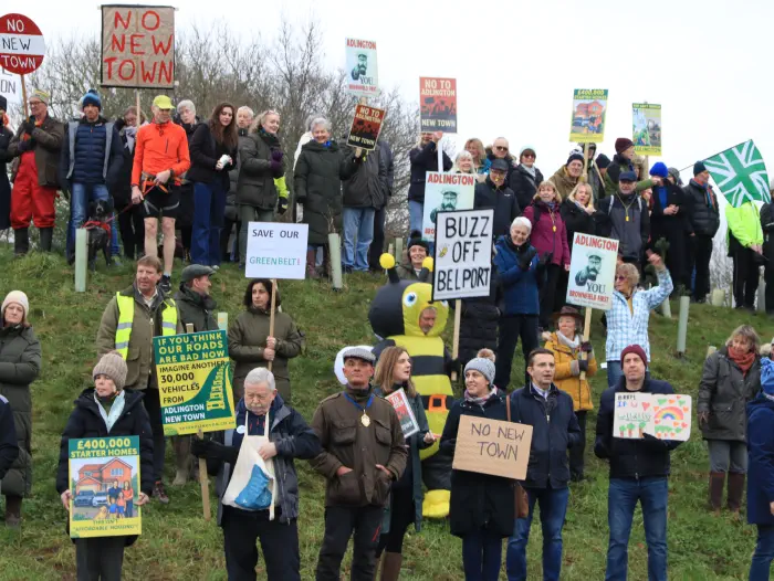 Protesters on embankment with banners and placards