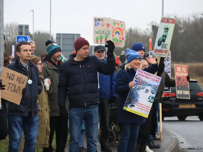 Protesters on roundabout with placards