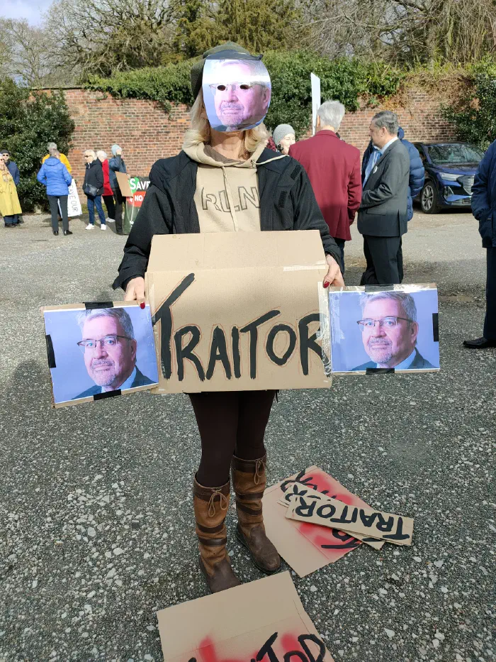 Protester displaying Traitor with Cllr Mannion's face