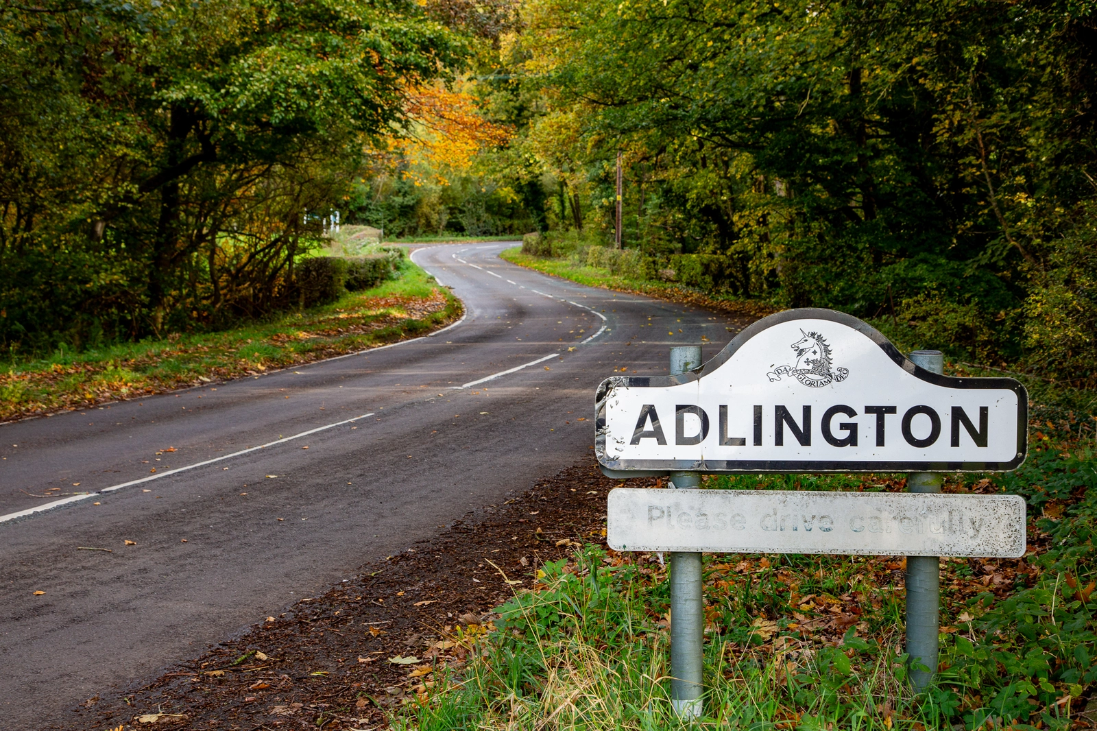 Adlington sign on autumnal road