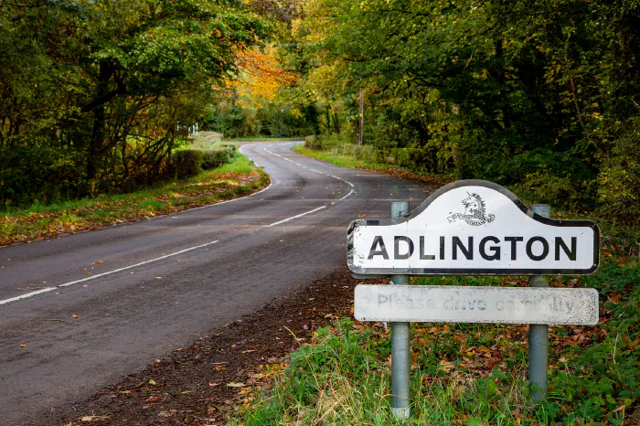 Adlington sign on autumnal road